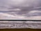 Moody beach with cloudy sky