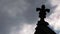 Moody clouds pass gothic church roof structure time lapse