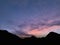 moody colored morning sky with mountain chains silhouette