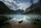 A moody day on the shores of an alpine lake blue with glacial silt in the rocky mountains