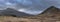 Moody and dramatic Winter landscape image of Moel Saibod from Crimpiau in Snowdonia with stunning shafts of light in stormy