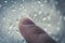 Moody Feelings Concept: Finger Of A Teenager Drawing On The Window With Raindrops On A Rainy Day