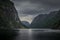Moody fjord with mountains and waterfall of Aurlandsfjord at Gudvangen in Norway
