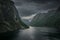 Moody fjord with mountains and waterfall of Aurlandsfjord at Gudvangen in Norway