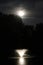 Moody Full Moon Over Pond With Fountain