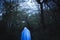 A moody horror edit of a blurred, dark ghostly figure Standing by a gate in a forest