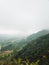Moody landscape: hilly terrain covered in clouds and fog