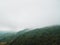 Moody landscape: hilly terrain covered in clouds and fog