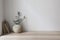 Moody Mediterranean home design. Vintage vase with olive tree branches. Old books on wooden table. Living room still