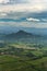 Moody, mysterious aerial view of green cultivated fields in front of mountains on island of Roatan, Honduras