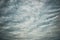 Moody overcast sky background, fleecy clouds texture, ominous skies in cold windy weather