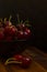 A moody photo of a bowl with fresh cherries