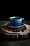 Moody Photo of Coffee Beans and a Cup with Freshly Brewed Coffee on a Dark Background