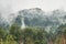 moody scene of mist rising from the pacific rain forests of chile