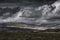 Moody sky with rainclouds over scenic mountain valley in Lake District, UK