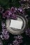 Moody spring wedding stationery mockup scene. Blank greeting card, invitation on vintage silver plate. Purple lilacs