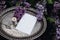 Moody spring wedding stationery mockup scene. Blank greeting card, invitation on vintage silver tray. Purple lilacs