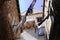 Moody street corner with old townhouses with laundry hanging between buildings - mediterranean sea