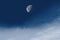 moon in the blue sky with white clouds