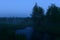 Moon in the clear blue night sky over the forest moonlight in the water reflection in the forest river