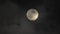 Moon in the clouds. Mystery of the night sky. Clouds are flying fast in front of the Moon