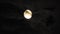 Moon with clouds in the night sky. Cloudy weather on a autumn night. Mysterious night sky with moon. Spooky night and mystery. Dr