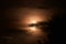 Moon through clouds. photographed with exposure time. clouds in the dark. forest silhouette at night