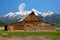 Moon going down over the Grand Tetons behind the T.A. Moulton barn on Mormon Row