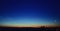 Moon and jupiter rising above the horizon at sunrise with noctilucent clouds on colorfully clouds