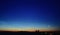 Moon and jupiter rising above the horizon at sunrise with noctilucent clouds on colorfully clouds