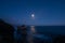 The moon lights the natural rock formations of El Matador Beach, Malibu, CA