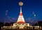 Moon on night sky over white pagoda.