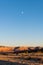 Moon over a colorful desert landscape at dusk over Ghost Ranch in New Mexico