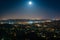 The moon over Northeast Los Angeles at night, seen from Griffith