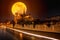 Moon over Notre Dame cathedral before it burned with ships trails on the water at night in Paris