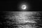 The moon over the sea horizon at night. moonlight on the waves