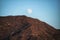 Moon peeping over the volcanic mountains