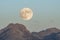 Moon rise over rugged mountains