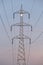 Moon rising from behind a huge electricity pole