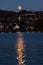 Moon rising over the hills on Zurich Switzerland lakeside point of view late evening