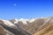 Moon rising over Mountain Tibetan Himalayan landscape in SiChuan province, China