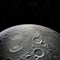 Moon\\\'s rugged surface from space, showing a partial view of its diameter against a black starry background