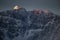 Moon sets below the mountains