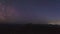 Moon setting behind the mountains and Milky Way appears in the night sky time lapse footage