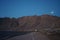 The moon shines over the mountains in Dahab, South Sinai Governorate, Egypt