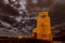 Moon shining through the clouds on a moody night at a historic grain elevator in Saskatchewan, Canada