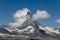 Moon shining over the famous matterhorn with clouds and blue sky