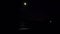 Moon in sky and moonlight path on sea waves on beach of sea coast seashore night