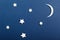 Moon and stars on blue background top view. Night sky objects with shadow close up. Decorative backdrop. Childish applique,