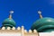 Moon between top of the tiled dome of mosque